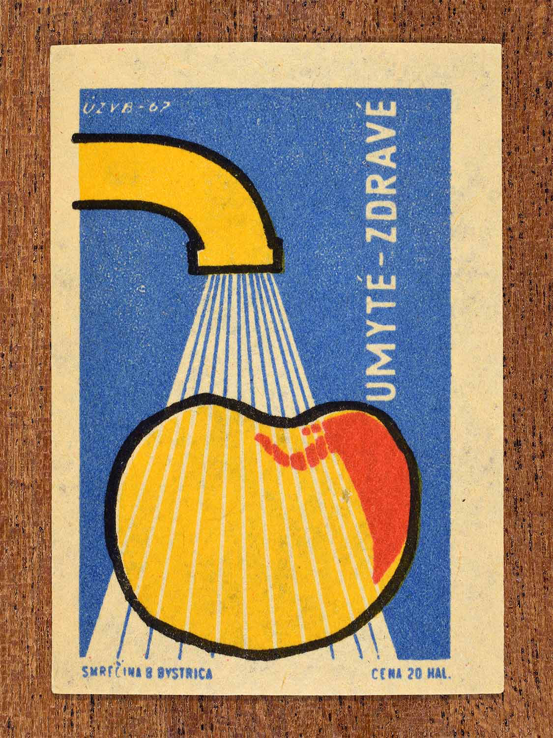 Vintage 1967 Czech matchbox label showing an apple being washed under running water in blue and yellow colours. Produced by the Smrečná match factory, Banská Bystrica, to promote washing food for better health.