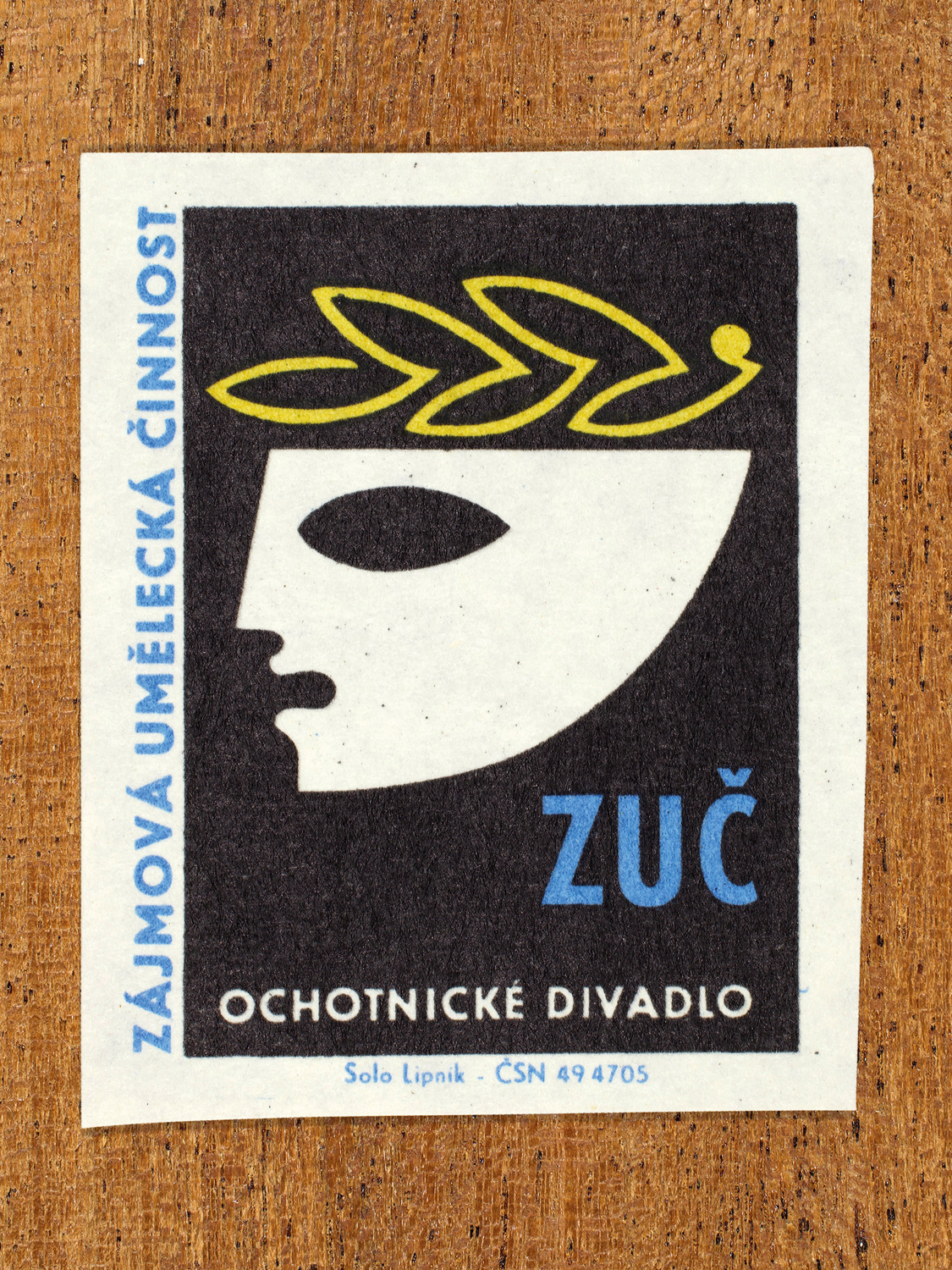 Vintage 1969 Czech matchbox label showing a stylised theatrical mask with a laurel wreath above, in blue, yellow and black colours. Produced by the Solo Lipník match factory to promote state-organised art groups in Czechoslovakia.