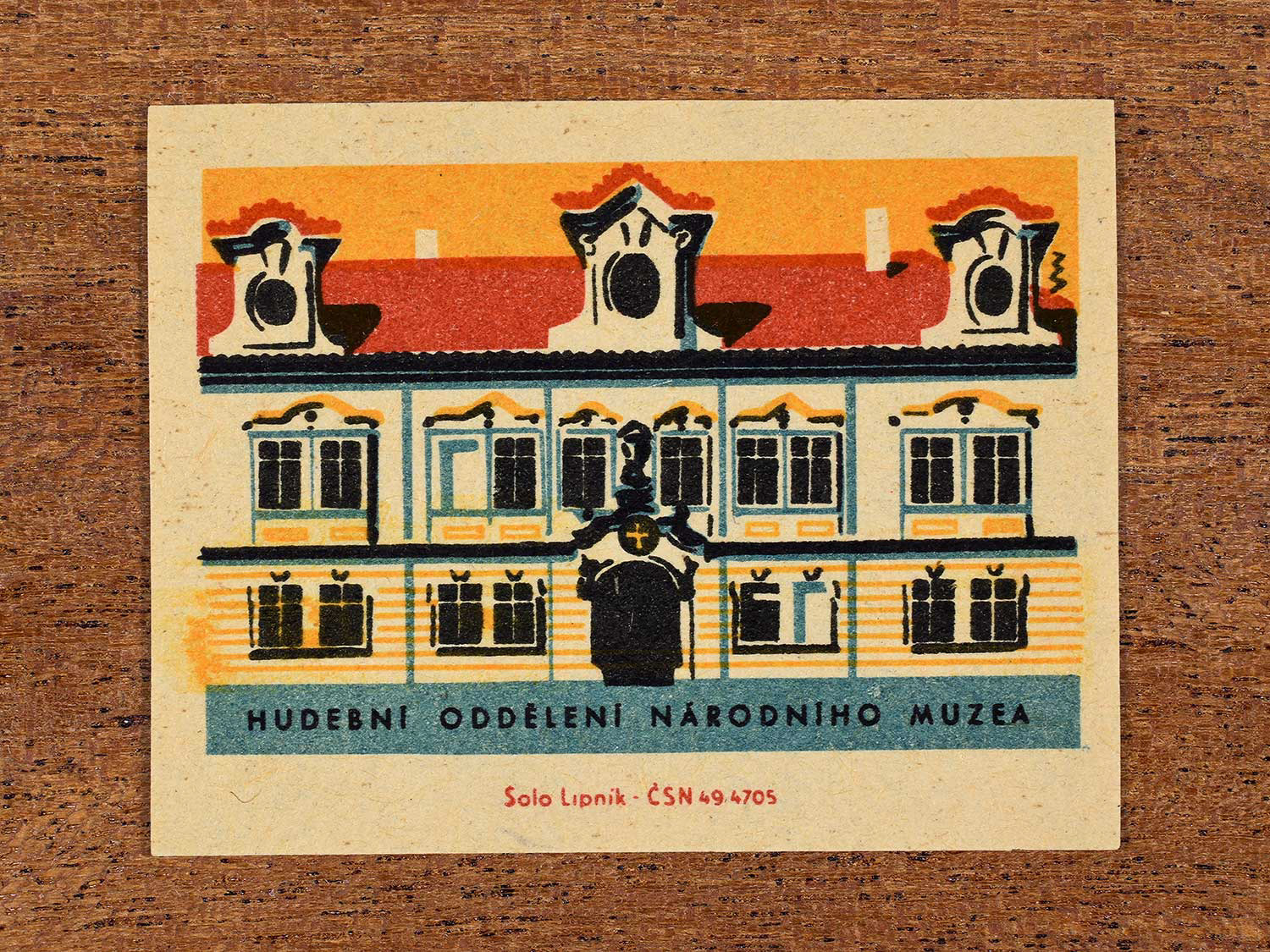 Vintage 1964 Czechoslovakia matchbox label showing the Hudební Oddělení Národního Muzea (Music History Department of the National Museum) in yellow, red and teal colours. Produced by the Solo Lipník match factory to promote domestic historical heritage and municipal institutions across the state.