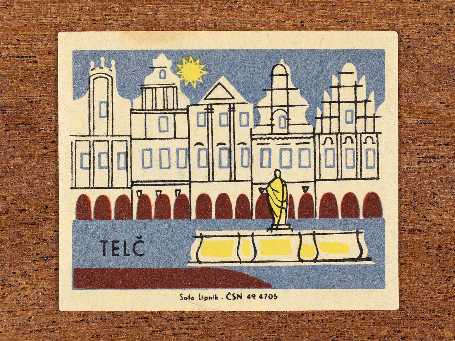 Vintage c. 1967 Czech matchbox label showing the historic town of Telč in blue, red and yellow colours. Produced by the Solo Lipník match factory to celebrate regional Czechoslovakian towns and architectural heritage.
