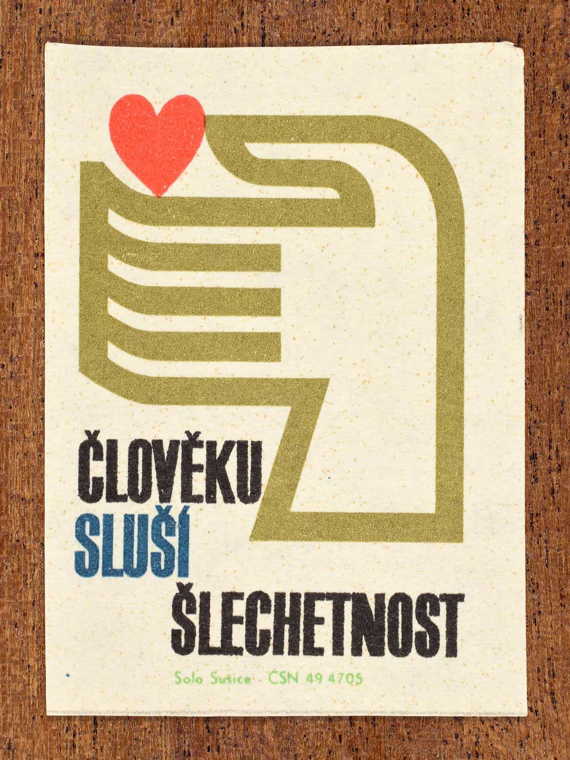 Vintage c. 1966 Czech matchbox label showing a human hand with a heart symbol positioned above the palm. Produced by the Solo Sušice match factory to promote moral nobility, kindness, and ethical character.