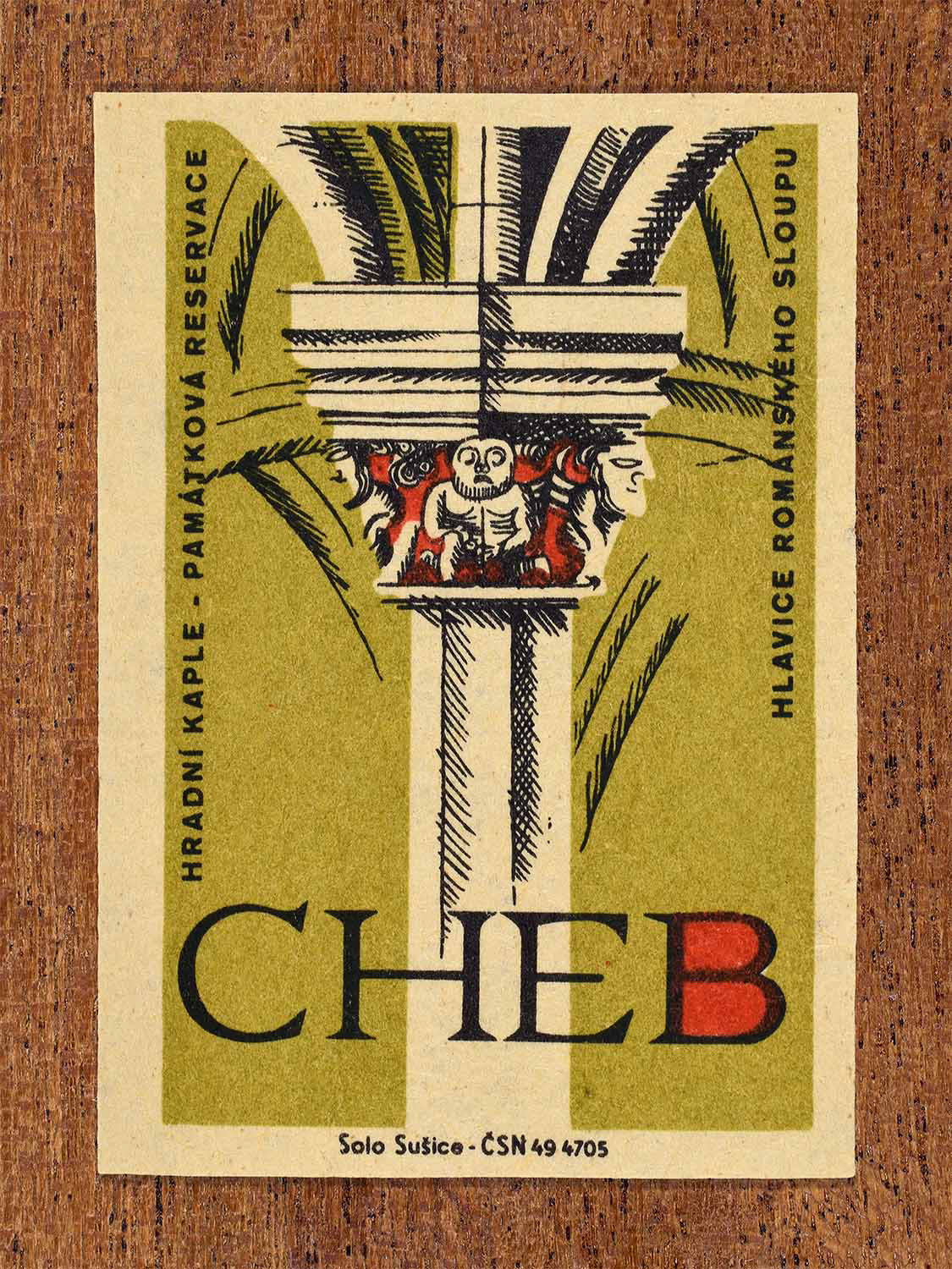 Vintage 1964 Czech matchbox label showing a Romanesque column capital from the castle chapel in Cheb, in olive and red colours. Produced by the Solo Sušice match factory to promote awareness of protected historic monuments.