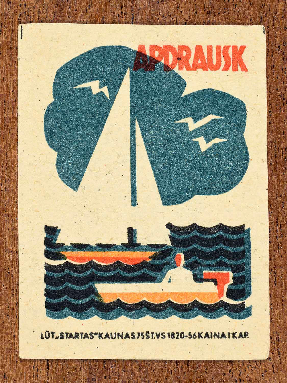 Vintage 1963 Lithuanian matchbox label showing a boat on the sea in blue, orange, and black colours. Produced by the Startas Kaunas match factory to promote insurance for property.