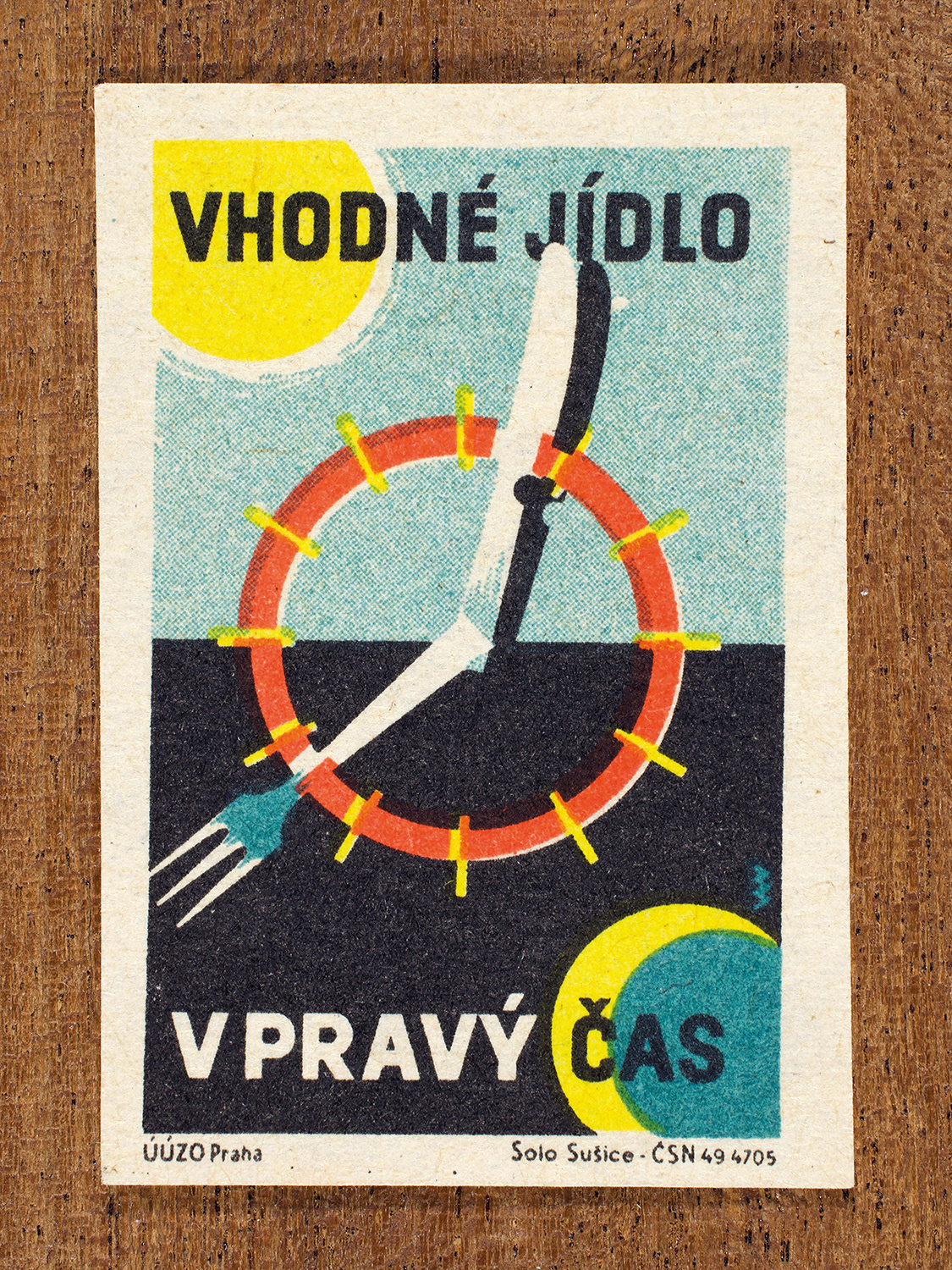 Vintage 1962 Czech matchbox label by Solo Sušice featuring a clock made of a fork and plate. Part of the 'Food Handling' series promoting healthy eating habits.