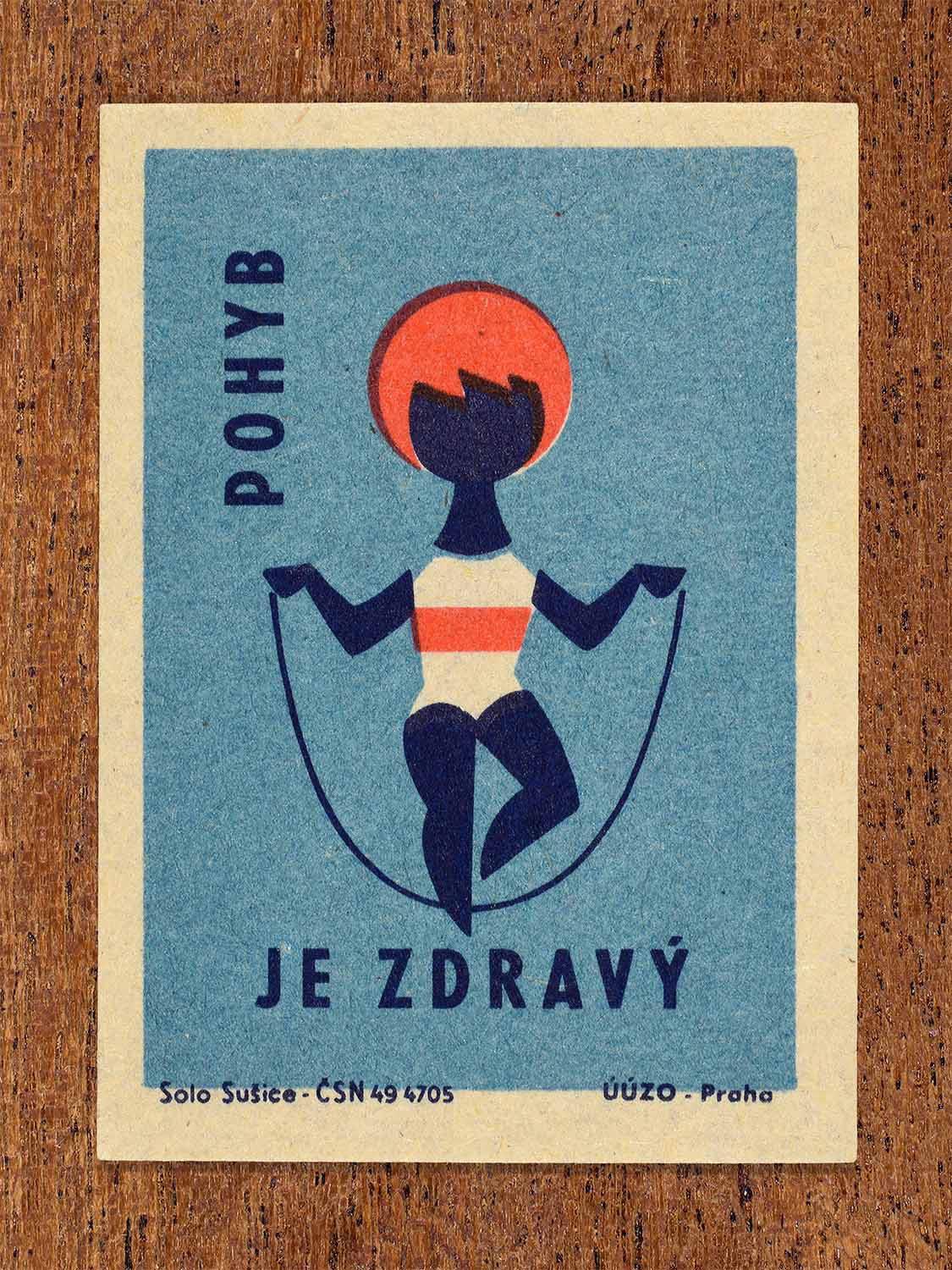 Vintage c. 1964 Czech matchbox label showing a stylised figure with a skipping rope in blue and red colours. Produced by the Solo Sušice match factory to encourage regular exercise for good health.