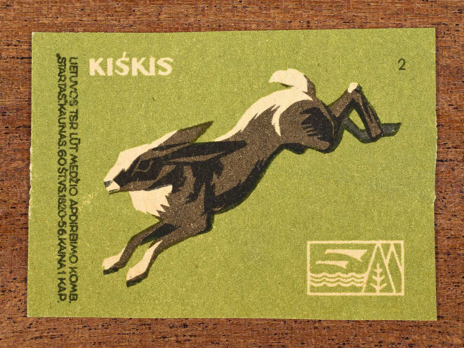 Vintage 1959 Lithuanian matchbox label showing a stylised dark-brown hare leaping, on green background. Produced by the LŪT Wood Processing Combine “Startas” in Kaunas to familiarise citizens with local wildlife.