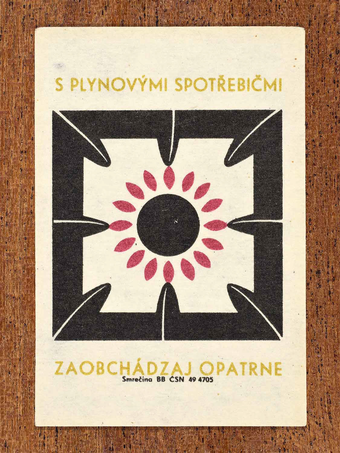 Vintage 1964 Czechoslovak matchbox label showing stylised top-down view of single gas stove in black, red and yellow colours. Produced by the Smrečina match factory to promote careful handling of home appliances.