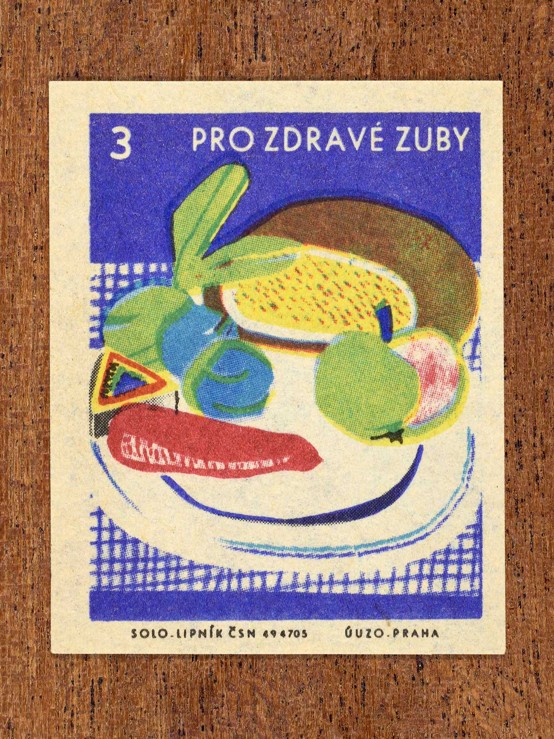 Vintage c. 1965 Czech matchbox label showing a plate full of fruit arranged on a tablecloth. Produced by Solo Lipník match factory to promote the health benefits proper nutrition, daily meal routines, and everyday household habits.