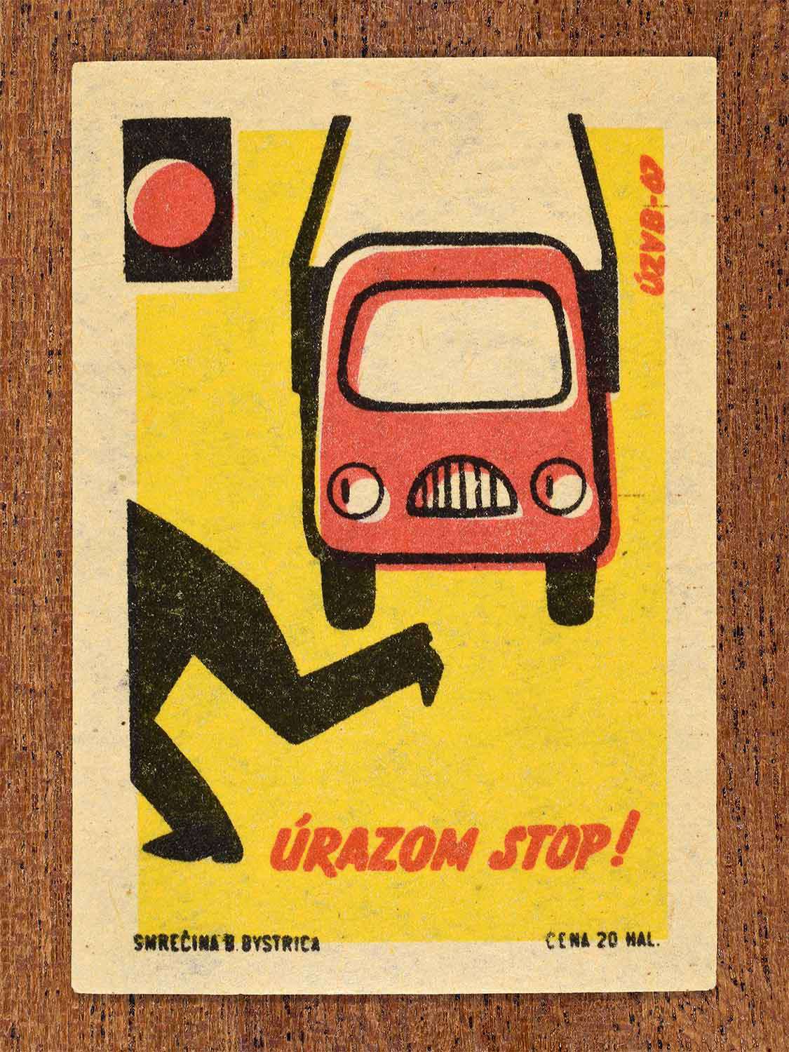 Vintage 1967 Czech matchbox label showing a pedestrian and a red car against bright yellow background. Produced by the Smrečná match factory, Banská Bystrica, to promote accident prevention and traffic safety.
