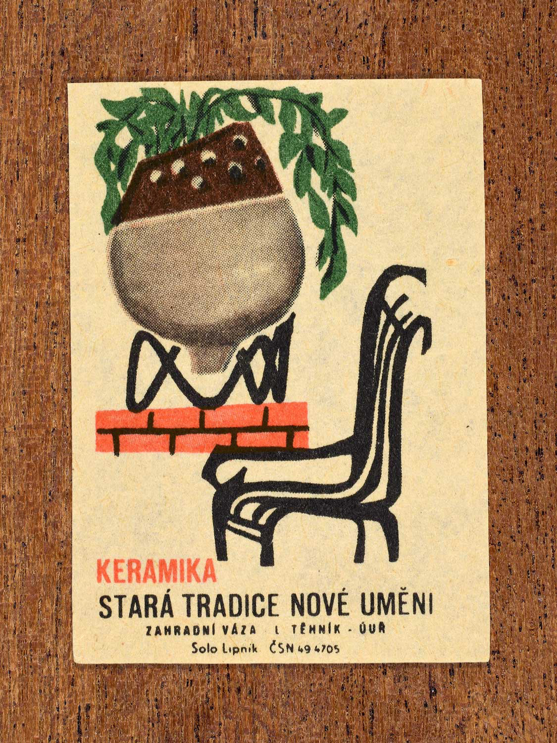 Vintage 1964 Czech matchbox label showing showing a 1ceramic garden vase used in a domestic setting. Produced by the Solo Lipník match factory to promote ceramics as functional modern design.