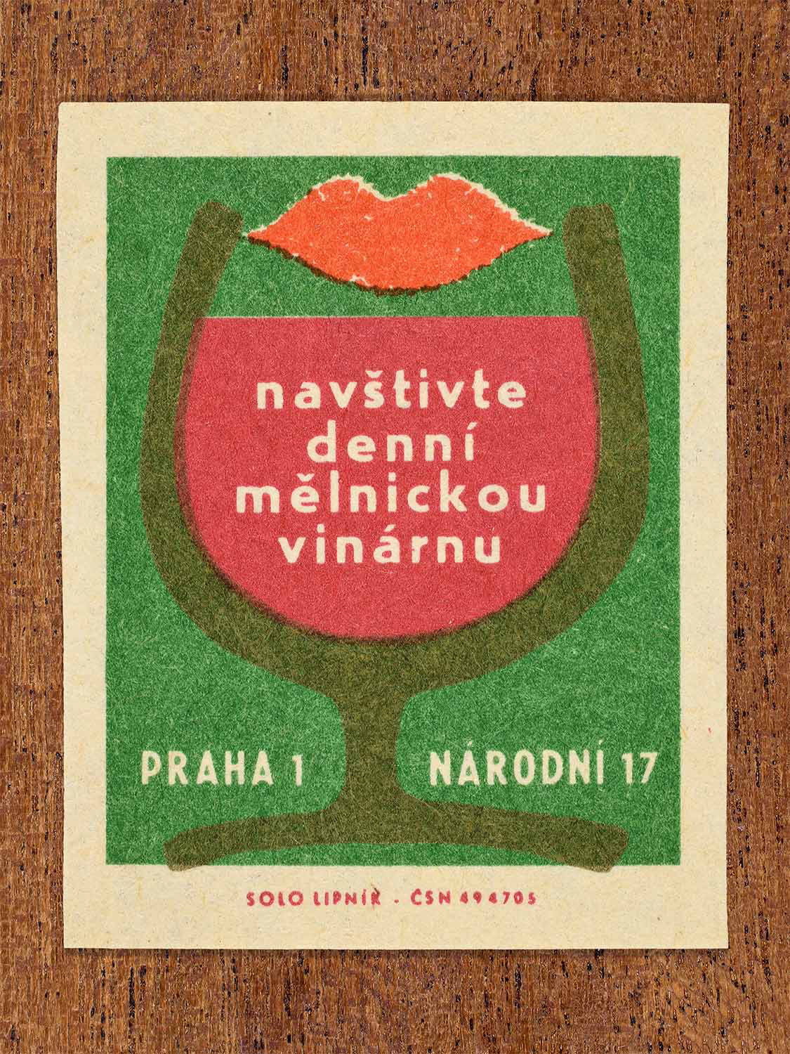 Vintage c. 1967 Czech matchbox labels showing a stylised wine glass with red wine and red lips on a green background. Produced by the Solo Lipník match factory to promote a daytime wine bar in Prague.
