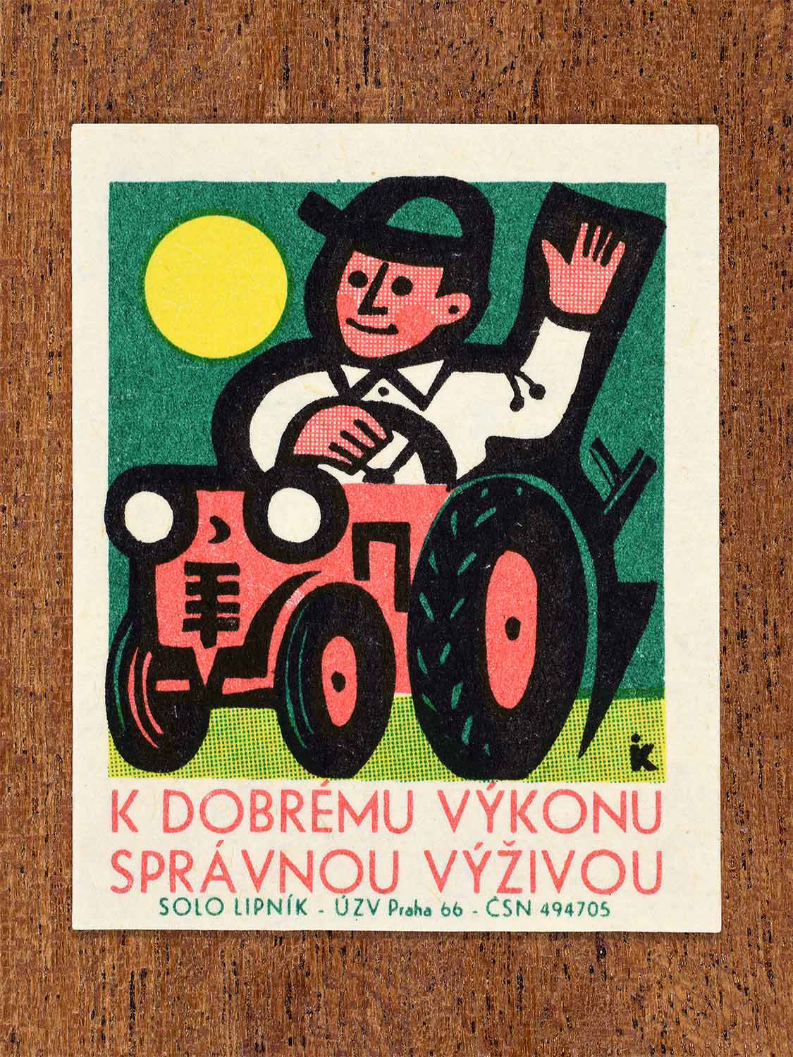 Vintage 1966 Czech matchbox label showing a smiling farmer driving a red tractor under the sun. Produced by the Solo Lipník match factory to promote proper nutrition for strong work performance.