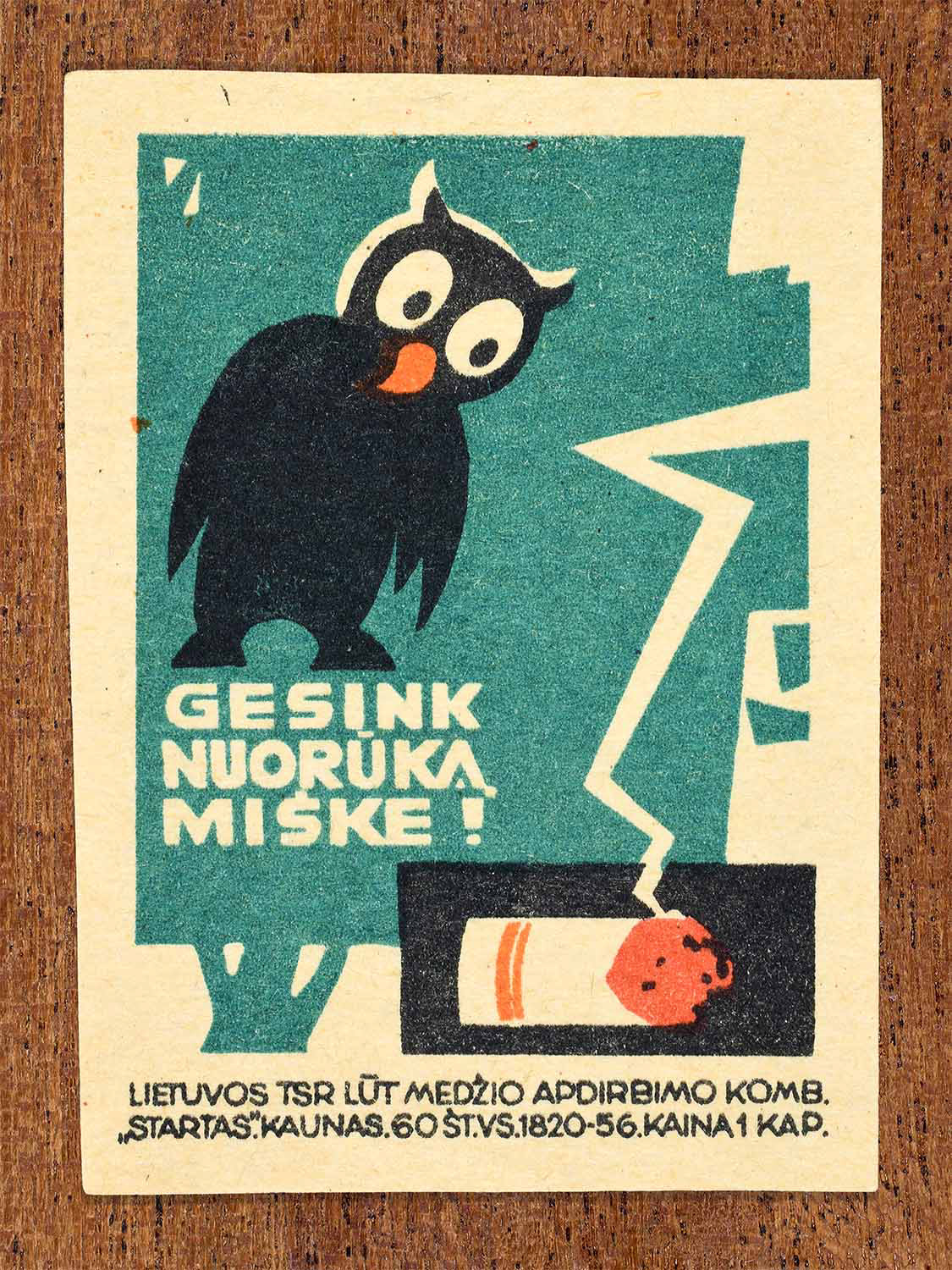 Vintage 1964 Lithuanian matchbox label showing an owl in a tree above a cigarette butt. In black, green and orange colours. Produced by the Startas match factory to promote forest fire prevention.