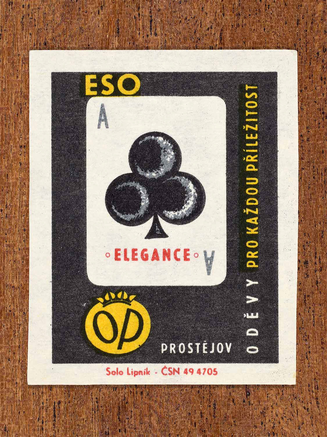 Vintage 1966 Czech matchbox label showing an ace of clubs playing card in black and white. Produced by the Solo Lipník match factory to associate OP Prostějov clothing with elegance.