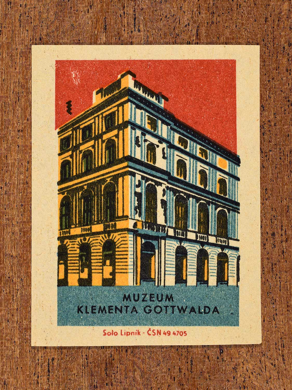 Vintage 1964 Czechoslovakia matchbox label showing the Muzeum Klementa Gottwalda (Klement Gottwald Museum) in yellow, red and teal colours. Produced by the Solo Lipník match factory to promote domestic historical heritage and municipal institutions across the state.