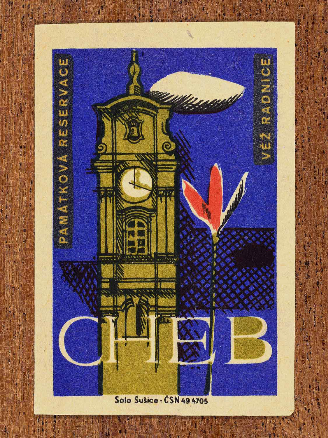 Vintage 1964 Czech matchbox label showing the town hall tower of Cheb in blue, red and olive colours. Produced by the Solo Sušice match factory to promote awareness of protected historic monuments.