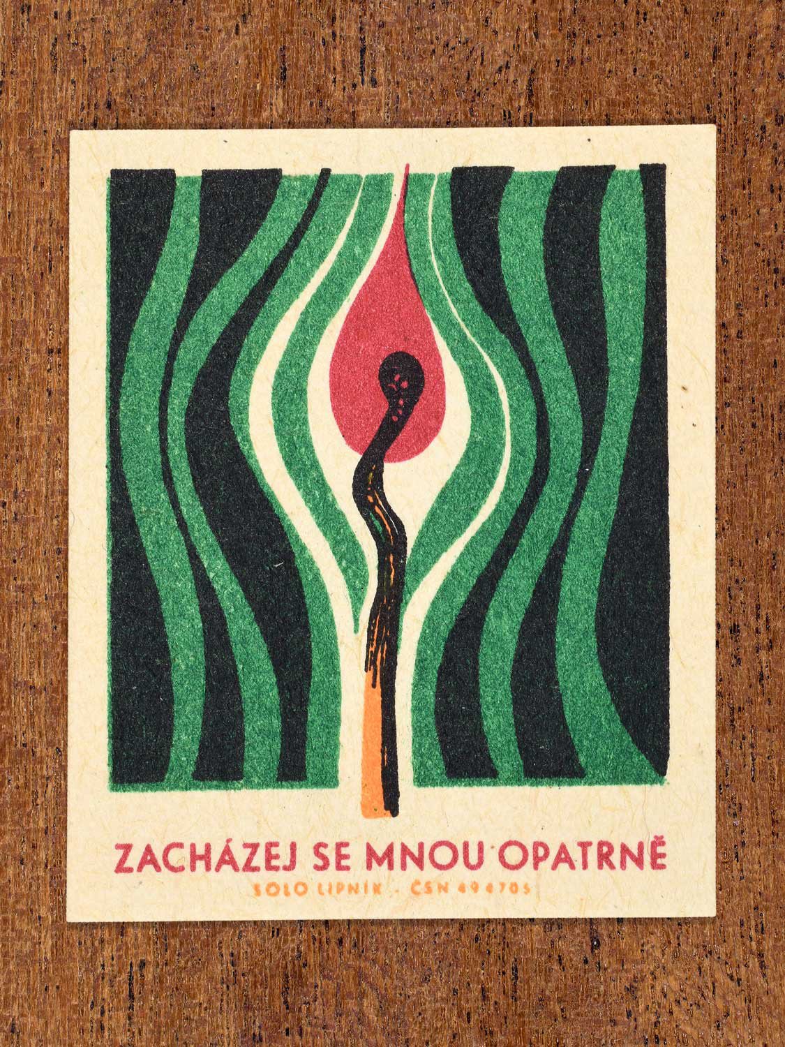 Vintage 1966 Czech matchbox label featuring a burning match and red flame with green, black and white wavy lines surrounding it. Produced by Solo Lipník match factory to promote the importance of fire safety precautions.