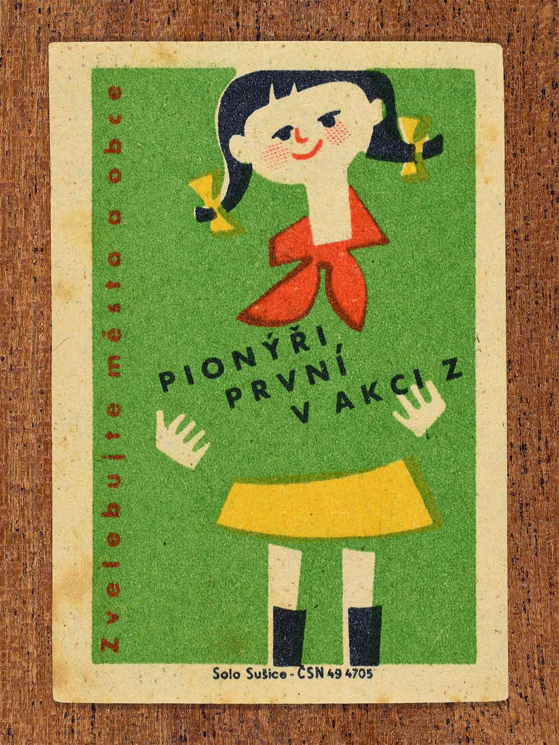 Vintage 1961 Czech matchbox label showing a young girl with pigtails and a red neckerchief on a green background. Produced by the Solo Sušice match factory to promote the civic improvement initiative known as Action Z.