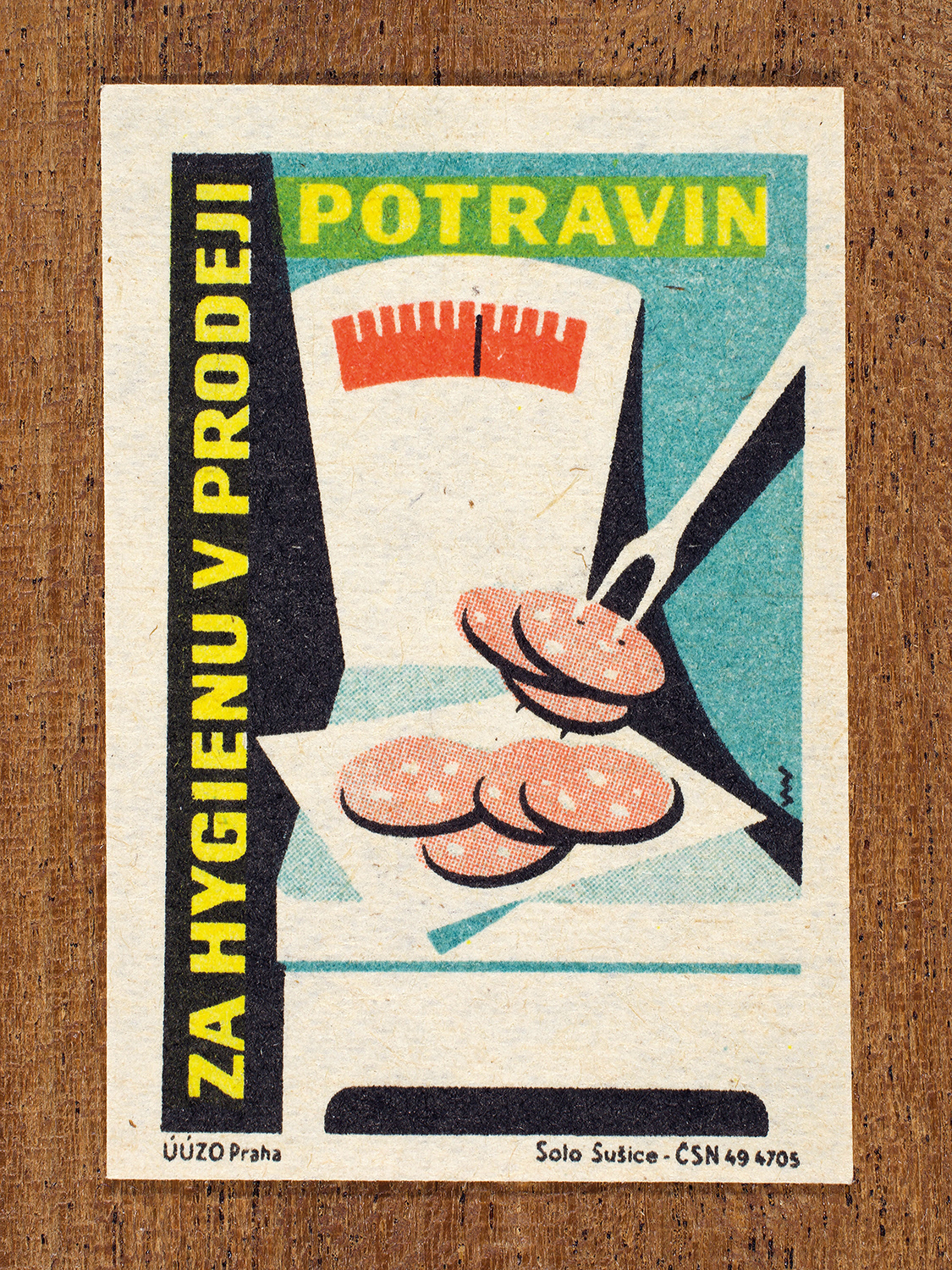 Vintage 1962 Czech matchbox label by Solo Sušice featuring a grocery scale weighing food slices. Part of the 'Food Handling' series encouraging clean and careful food handling in stores.