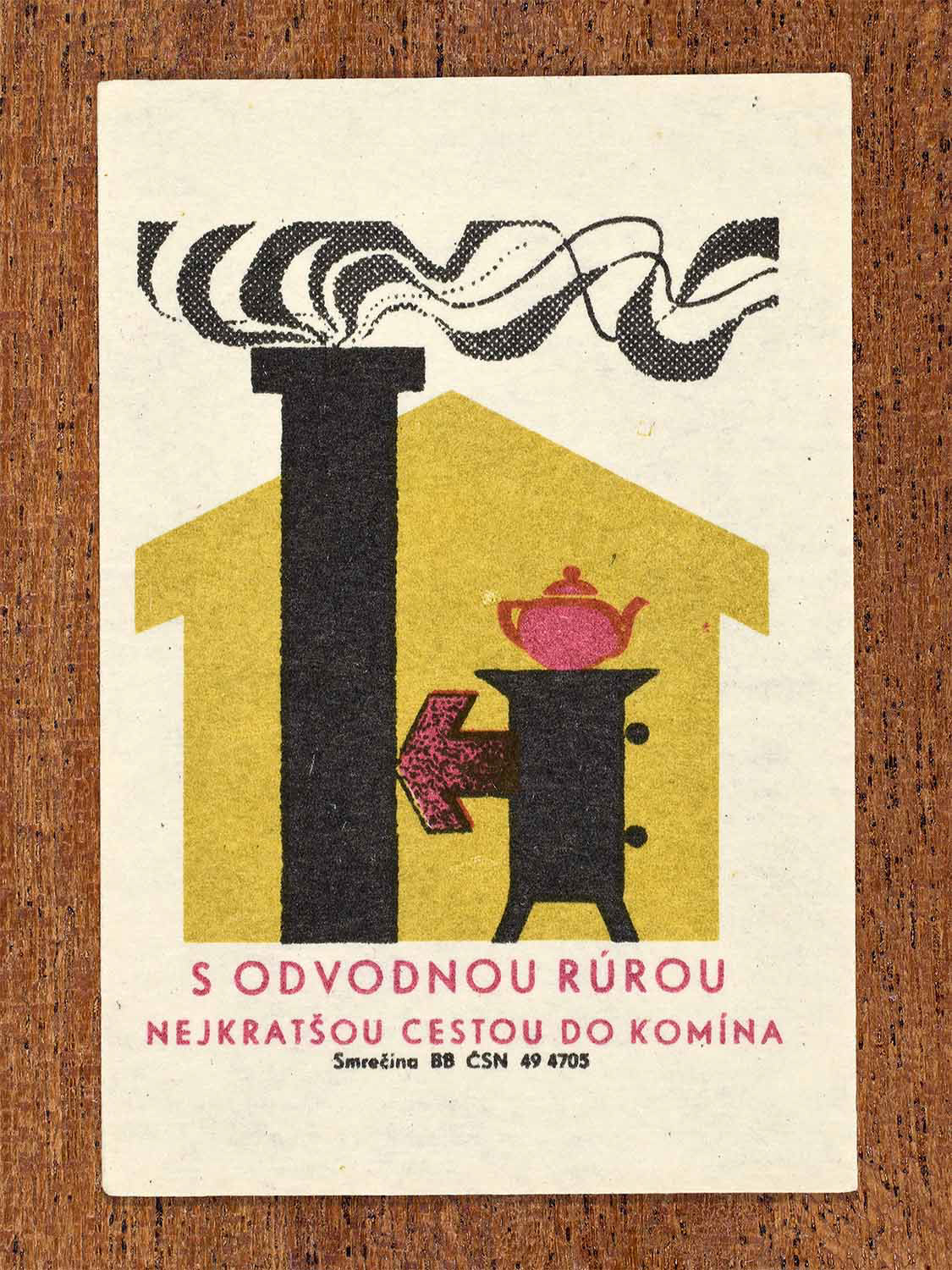 Vintage 1964 Czechoslovak matchbox label showing a stove pipe leading into a chimney inside a house shape in yellow, red and black. Produced by the Smrečina match factory to promote correct flue pipe installation.