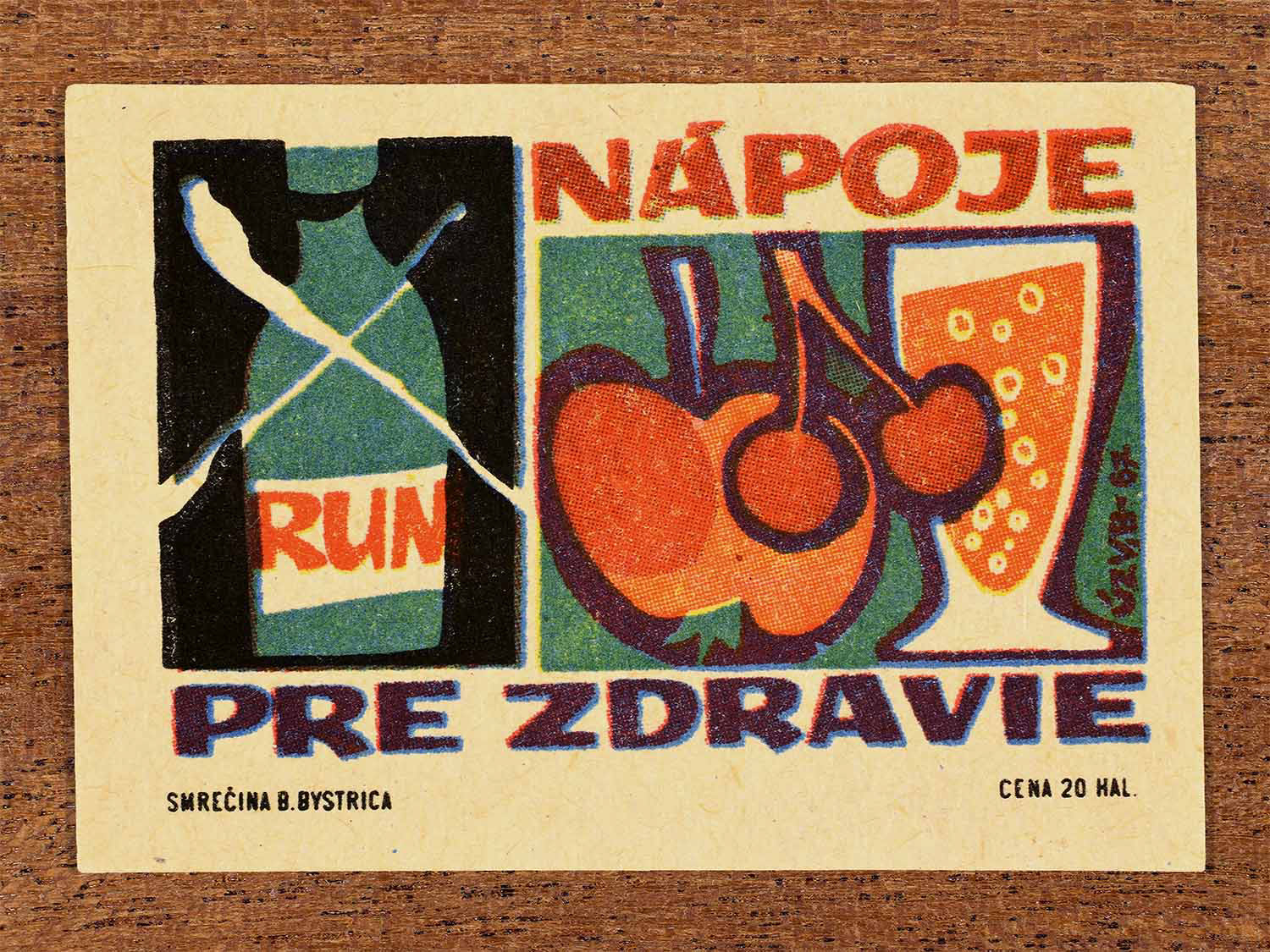 Vintage 1967 Czech matchbox label showing a bottle of rum crossed out, and a drinking glass with an apple and cherries. Produced by the Smrečná match factory, Banská Bystrica, to promote healthy beverages.