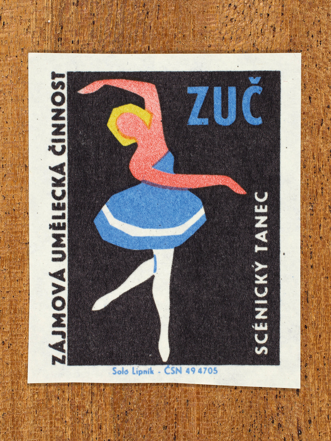 Vintage 1969 Czech matchbox label showing a ballerina balancing on one leg and extended arms, in blue, yellow and black colours. Produced by the Solo Lipník match factory to promote state-organised art groups in Czechoslovakia.