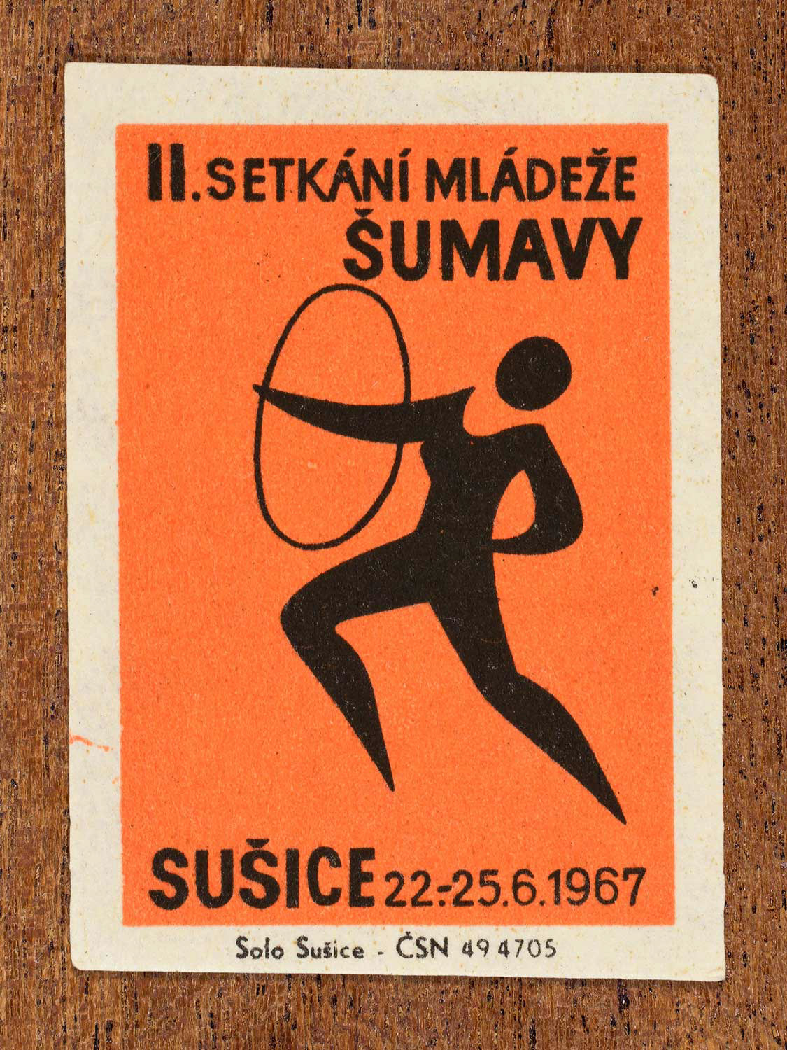 Vintage 1967 Czech matchbox label showing a youth performing a hoop-based gymnastics exercise. Produced by the Solo Sušice match factory to promote coordination and physical education within youth programmes.