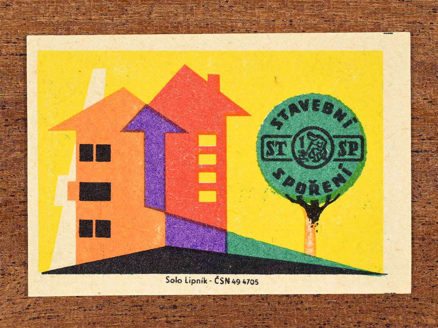 Vintage 1960 Czech matchbox label showing an abstract house and tree in bright colours. Produced by the Solo Lipník match factory to promote saving money to afford a home.