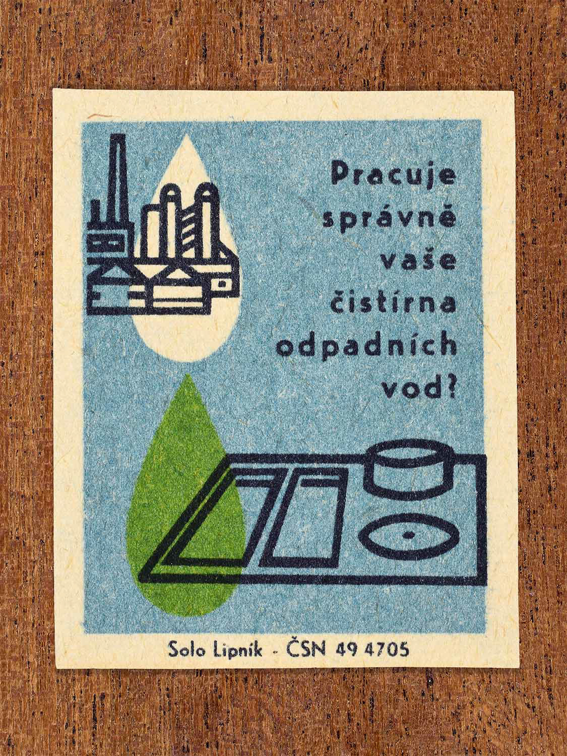 Vintage 1966 Czech matchbox label showing a factory and a wastewater treatment basin with a green water drop in blue and green colours. Produced by the Solo Lipník match factory to encourage proper operation of wastewater treatment facilities.