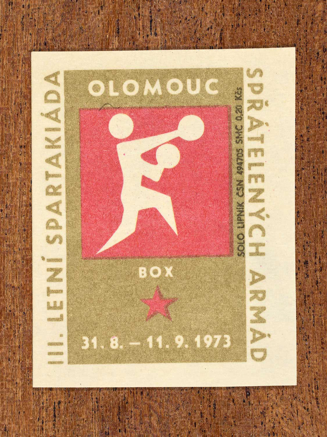Vintage 1973 Czech matchbox label showing a simplified white boxing figure on a red and gold background. Produced by the Solo Lipník match factory to promote physical training and demonstrate collective military readiness among allied armies.