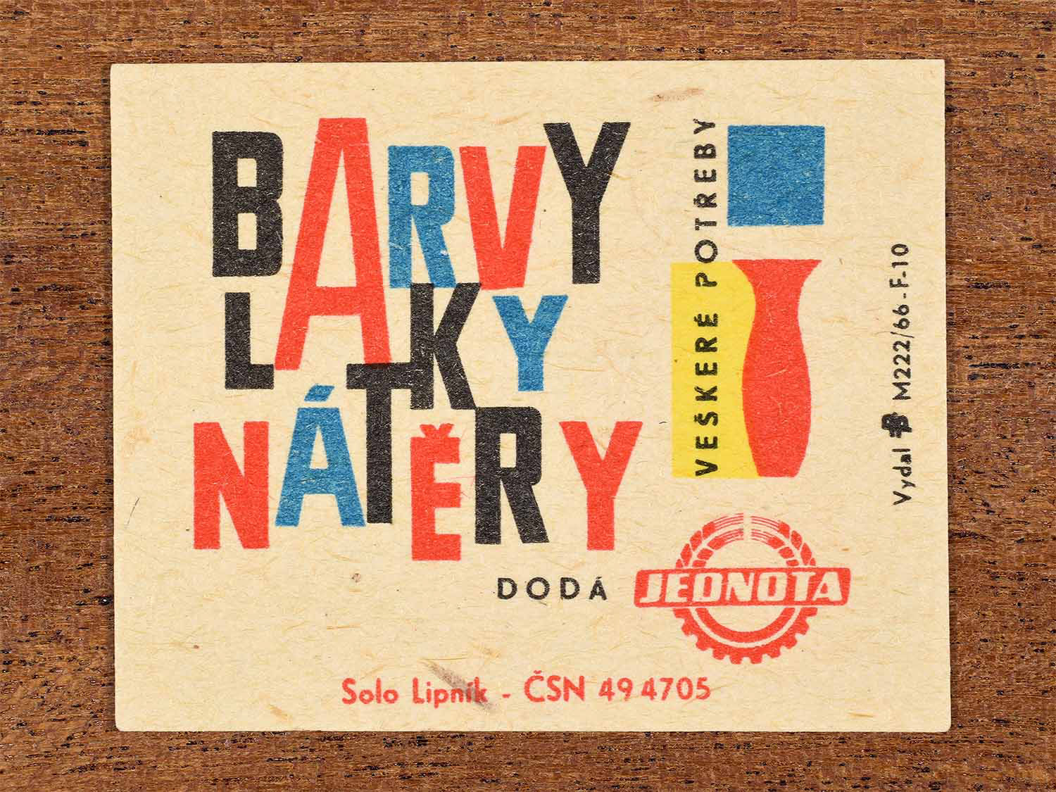 Vintage c. 1966 Czech matchbox label showing bold typographic lettering and stylised paint containers in bright red, blue and yellow colours. Produced by the Solo Lipník match factory to promote paint and coating supplies available from Jednota stores.
