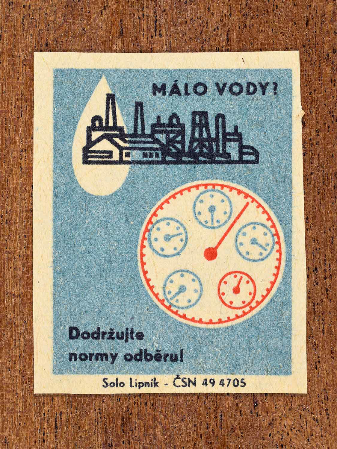 Vintage 1966 Czech matchbox label showing a water gauge dial beside an industrial skyline in blue and red colours. Produced by the Solo Lipník match factory to promote adherence to regulated water consumption limits.