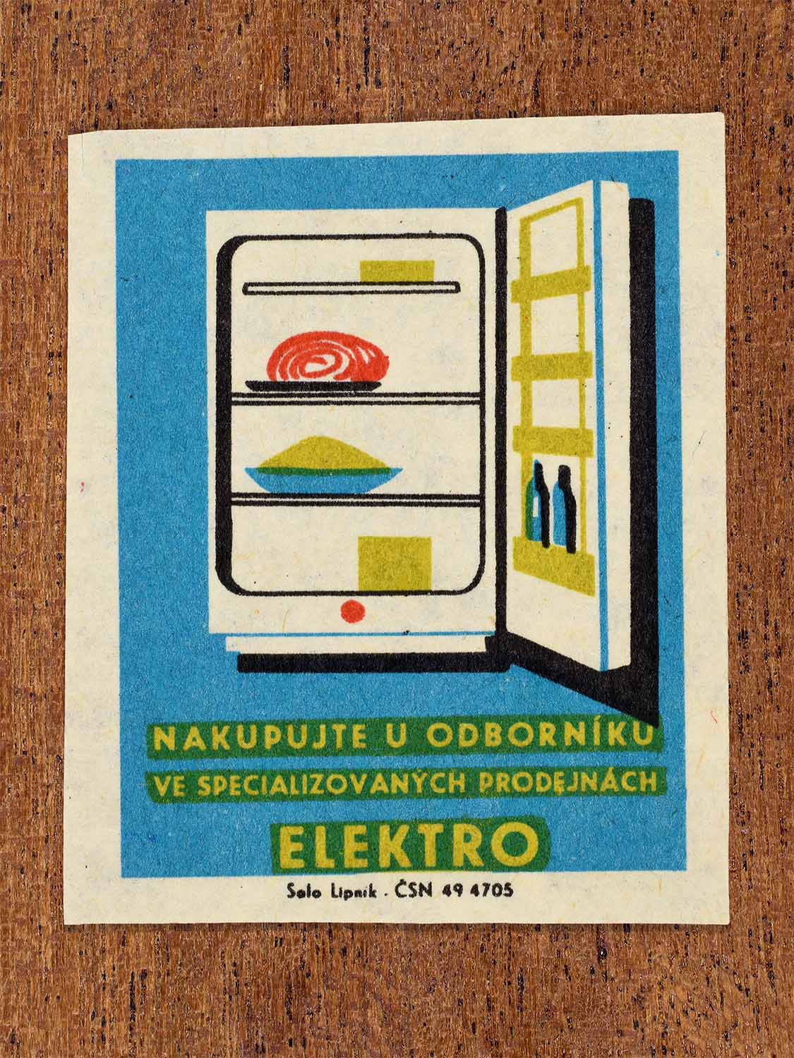 Vintage c. 1967 Czech matchbox label showing an open refrigerator with food and bottles in blue, yellow and red colours. Produced by the Solo Lipník match factory to promote shopping for electrical appliances in specialised retail stores.