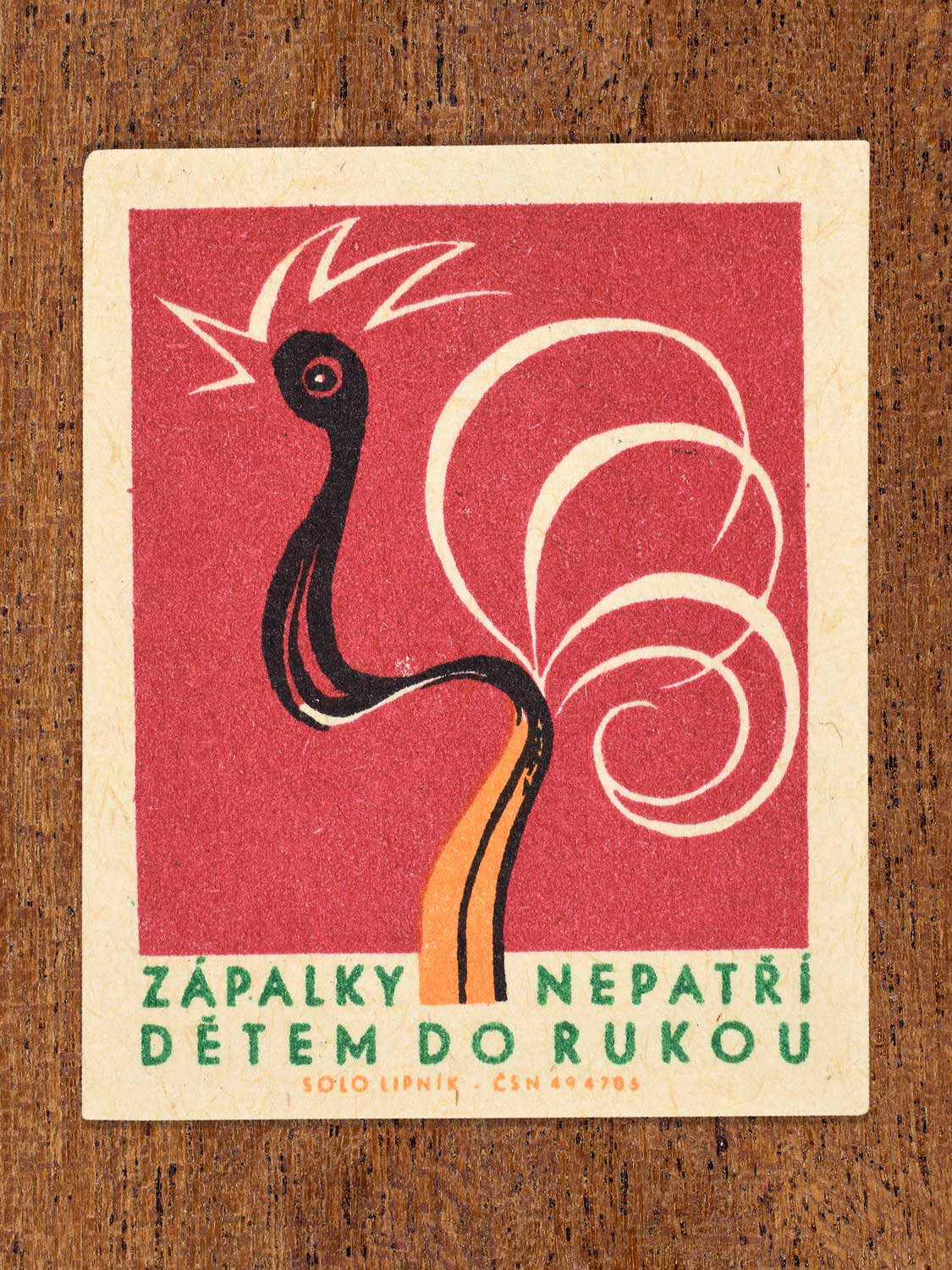 Vintage 1966 Czech matchbox label featuring a burnt match visualised as a cockerel on red background. Produced by Solo Lipník match factory to promote the importance of fire safety precautions.