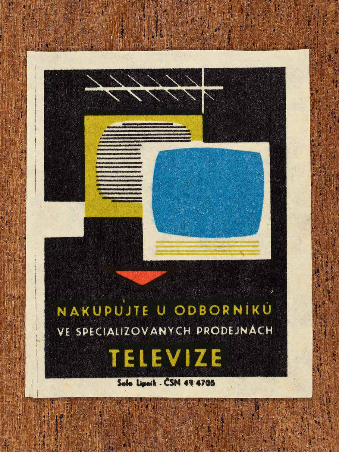 Vintage c. 1967 Czech matchbox label showing two television sets, one with an antenna. In blue, yellow, red and black colours. Produced by the Solo Lipník match factory to promote shopping for televisions in specialised retail stores.