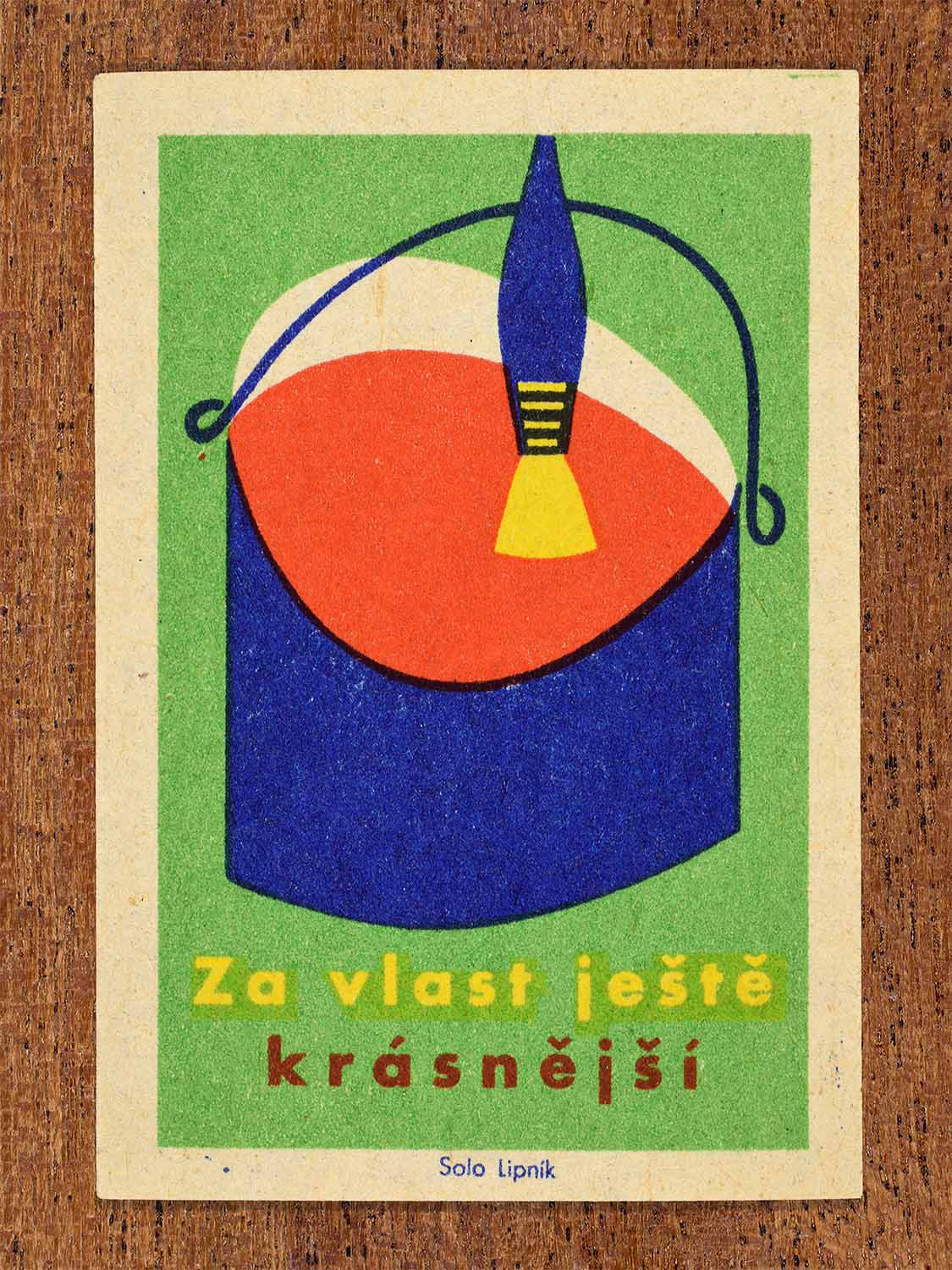 Vintage 1960 Czech matchbox label showing a paint tin and paint brush in blue, red, yellow and green colours. Produced by the Solo Lipník match factory to promote a more beautiful homeland through civic improvements.