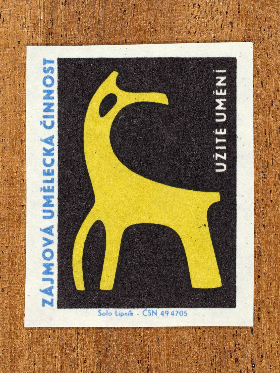 Vintage 1969 Czech matchbox label showing an abstract yellow animal-like form, in blue, yellow and black colours. Produced by the Solo Lipník match factory to promote state-organised art groups in Czechoslovakia.