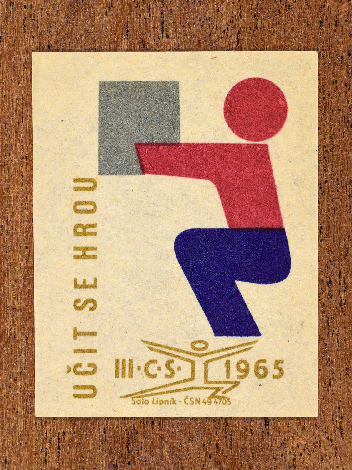 Vintage 1965 Czechoslovak matchbox label showing a stylised athlete performing a competitive discipline. Produced by the Solo Lipník match factory to promote physical fitness and sporting achievement.