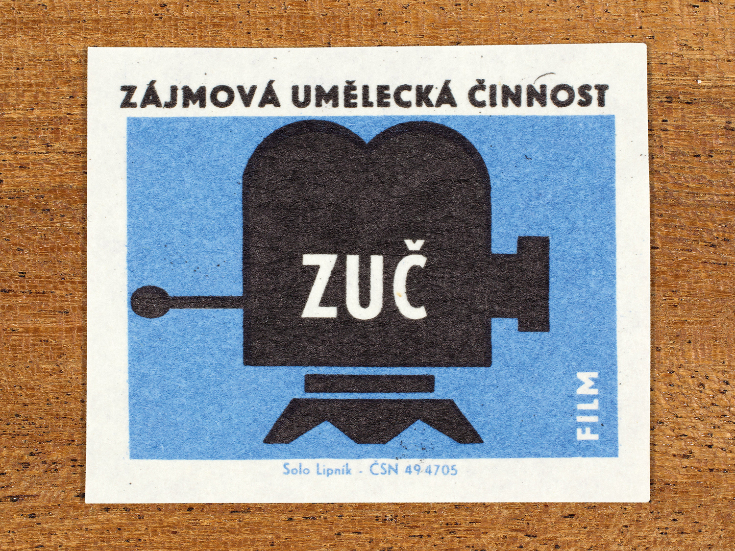 Vintage 1969 Czech matchbox label showing a stylised movie camera, in blue and black colours. Produced by the Solo Lipník match factory to promote state-organised art groups in Czechoslovakia.
