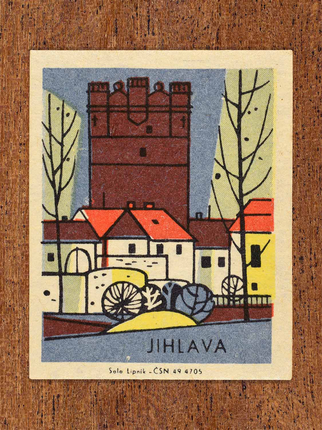 Vintage c. 1967 Czech matchbox label showing a stylised tower of Jihlava with surrounding town buildings, in blue, red and yellow colours. Produced by the Solo Lipník match factory to celebrate regional Czechoslovakian towns and architectural heritage.