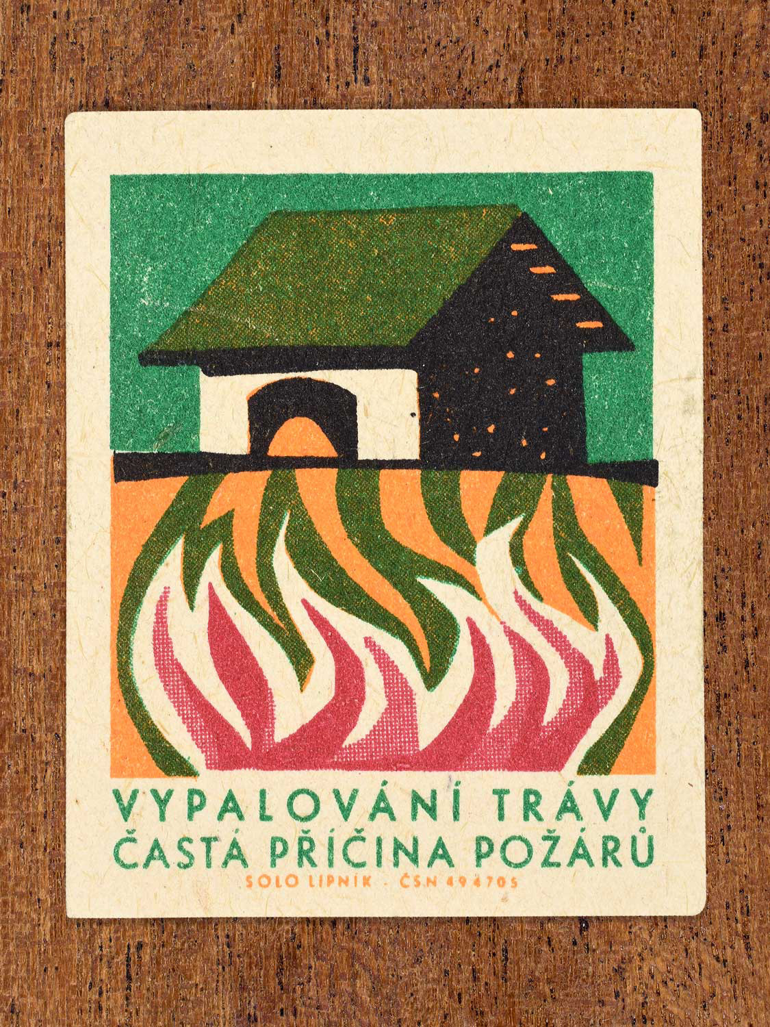 Vintage 1966 Czech matchbox label featuring a barn with orange, green and red flames rising from below. Produced by Solo Lipník match factory to promote the importance of fire safety precautions.