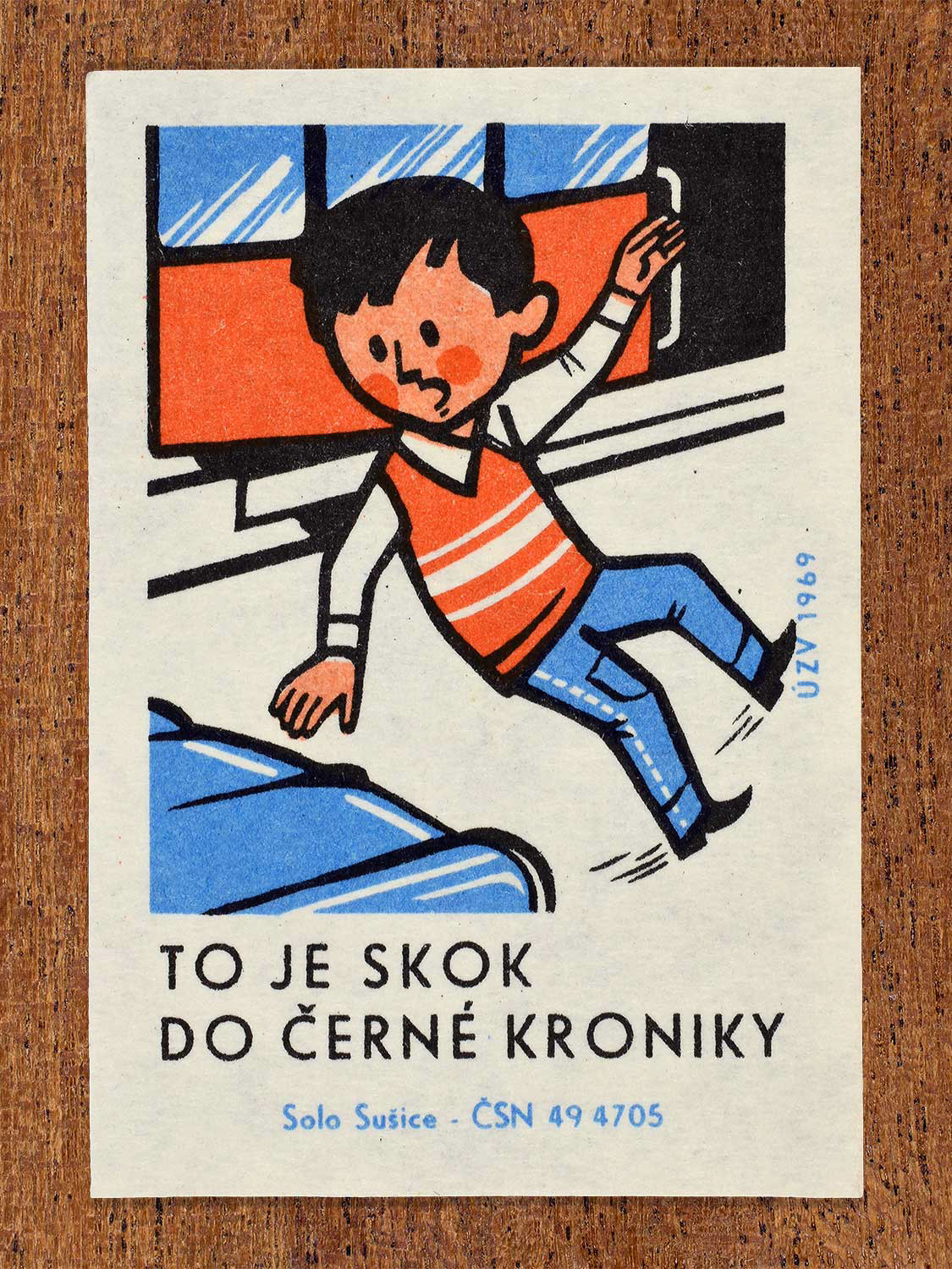 Vintage 1969 Czech matchbox label showing a reckless boy leaping off a tram directly in front of a moving blue vehicle. Produced by the Solo Sušice match factory to promote traffic vigilance and discourage sudden jumps into active streets.