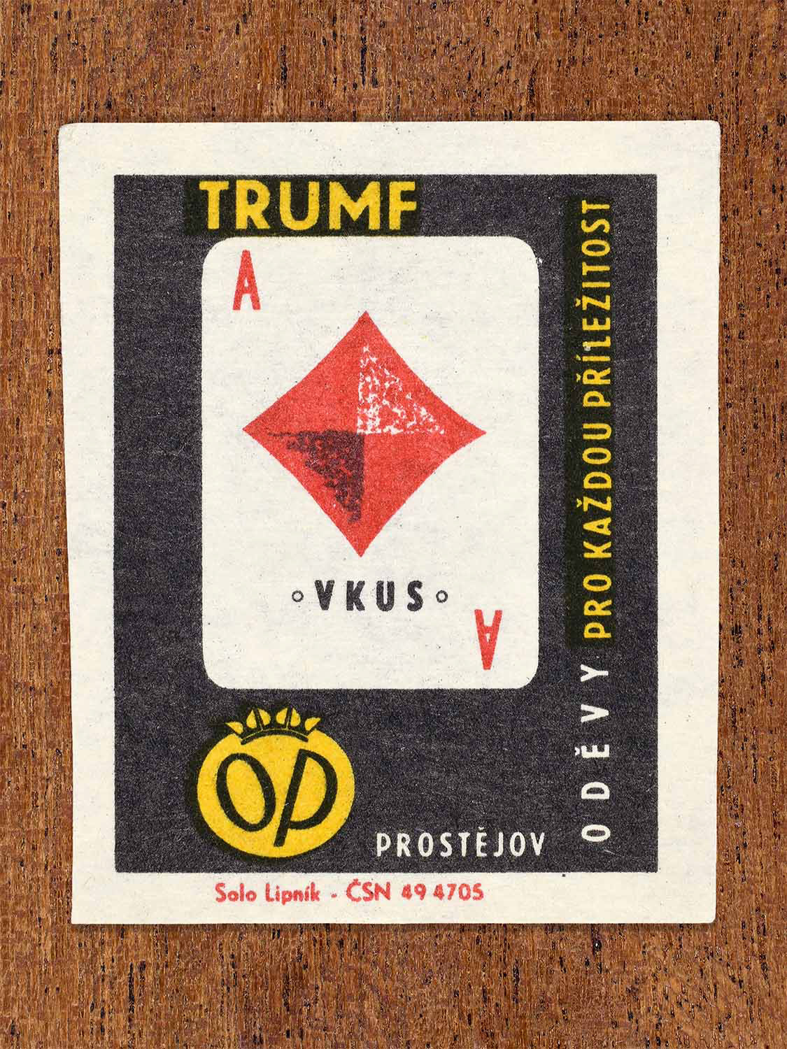 Vintage 1966 Czech matchbox label showing an ace of diamonds playing card in red. Produced by the Solo Lipník match factory to convey good taste in OP Prostějov clothing.