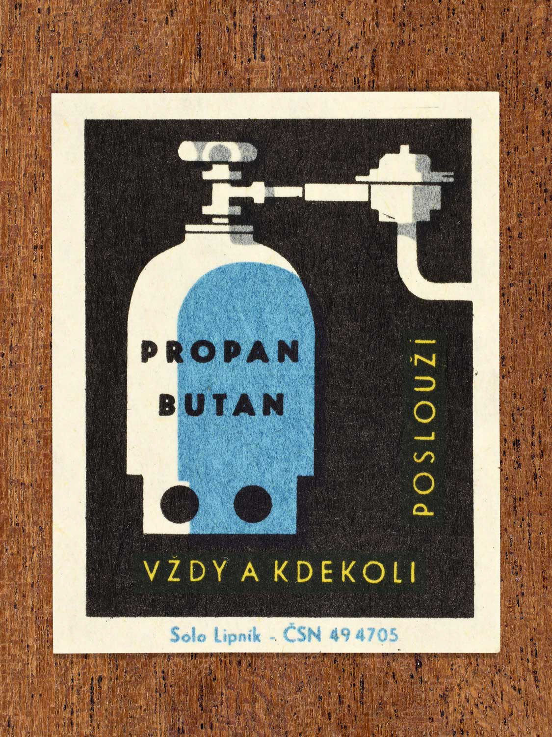 Vintage c. 1966 Czech matchbox label showing a propane–butane gas cylinder with valve in blue, yellow and black colours. Produced by the Solo Lipník match factory to promote safe, modern, and responsible domestic propane–butane gas use.