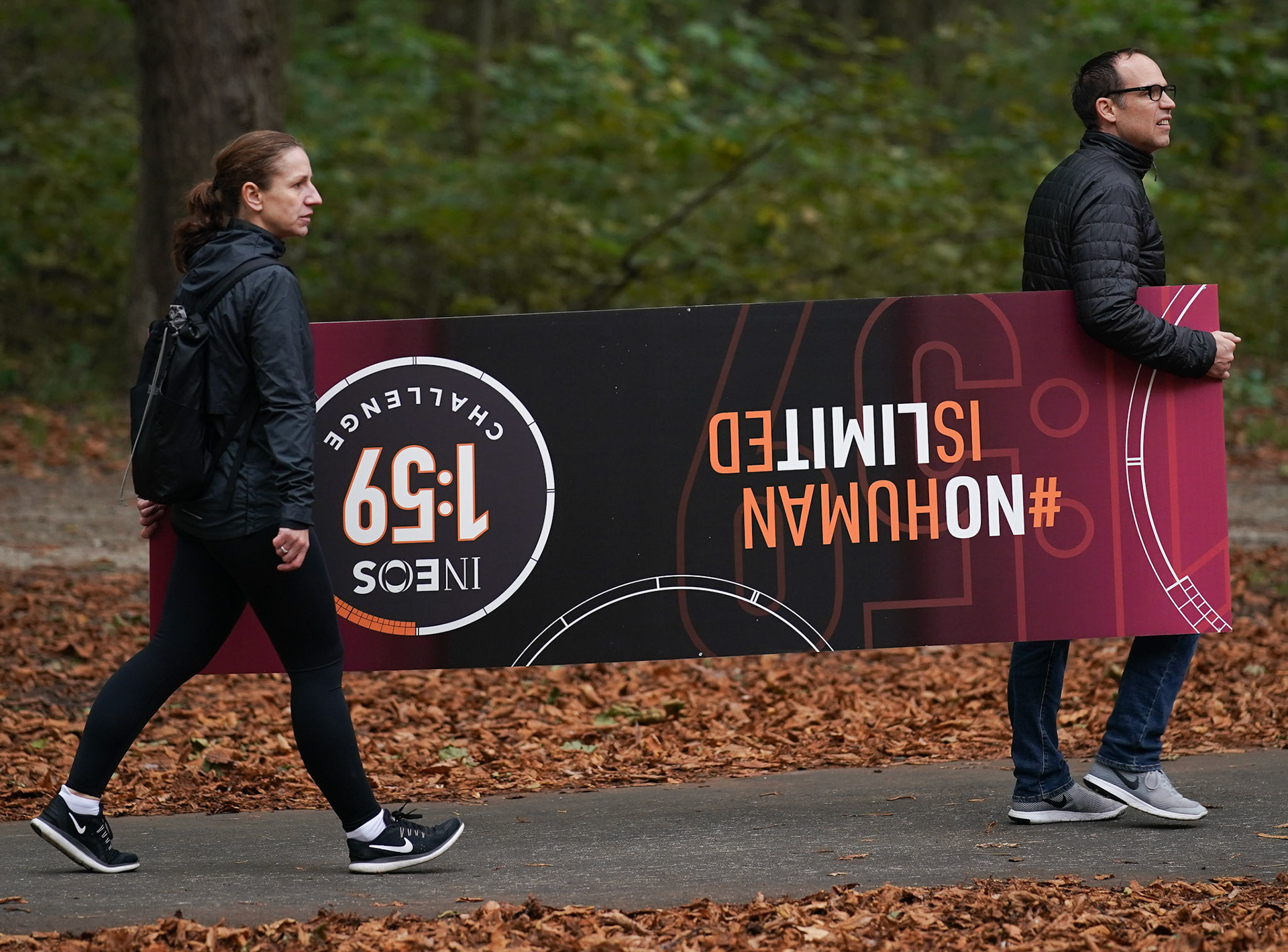 Free for editorial use and archive. Two people carry one of the No Human is Limited hoardings trough the park.
The INEOS 1:59 Challenge, Vienna, Austria. 12 October 2019.
Photo: Joe Toth for The INEOS 1:59 Challenge