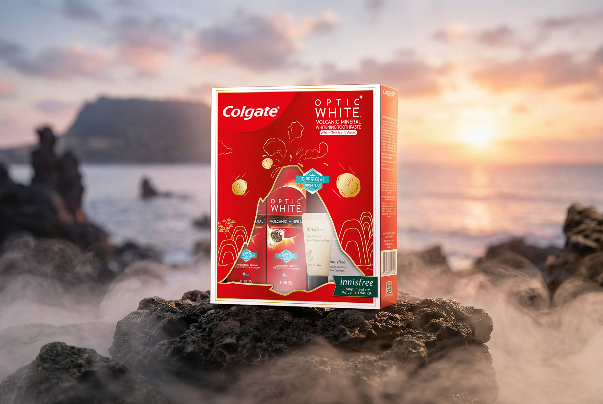 Colgate Optic White Volcanic Mineral × Innisfree gift box photographed on Jeju Island volcanic rock — co-branded packaging design by Laugh Contagious Communications, creative agency in Kuala Lumpur