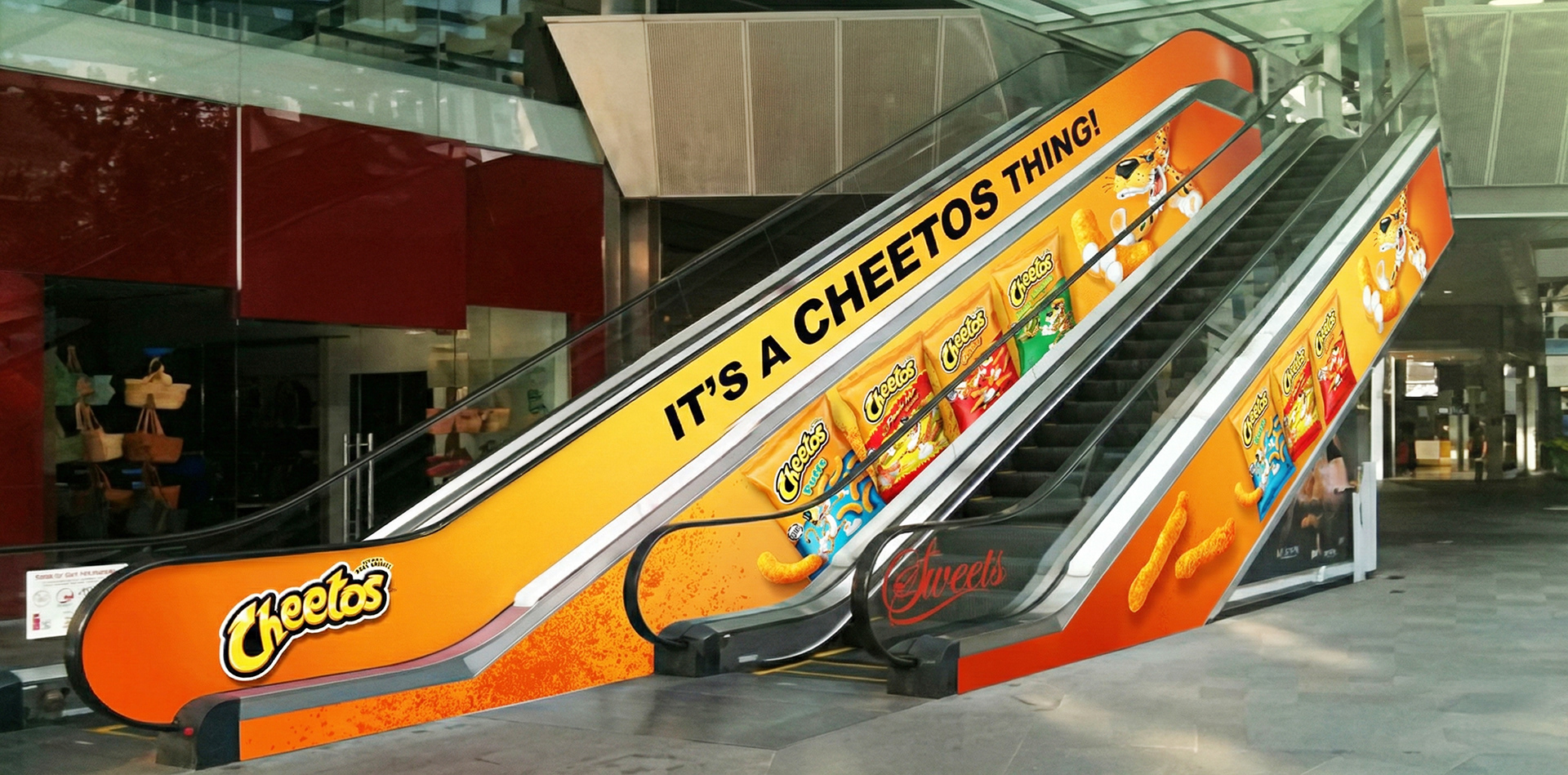 Cheetos It's a Cheetos Thing branded mall escalator wrap — ambient retail POSM by Laugh Contagious Malaysia