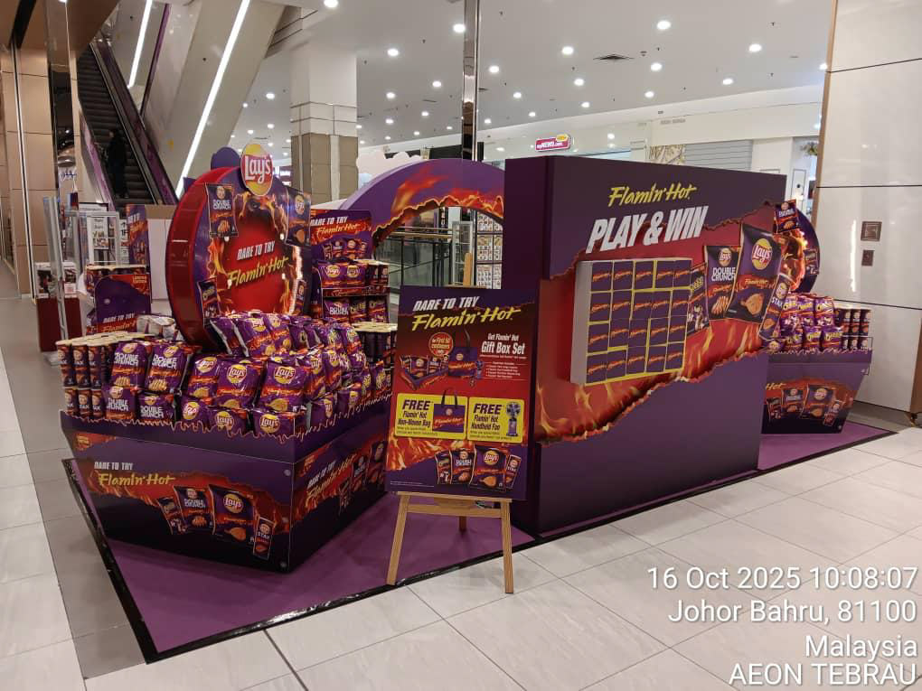 Another angle of the deployed activation — shoppers approaching the dare in the mall atrium space, with the gamified mechanic and product walls clearly visible.