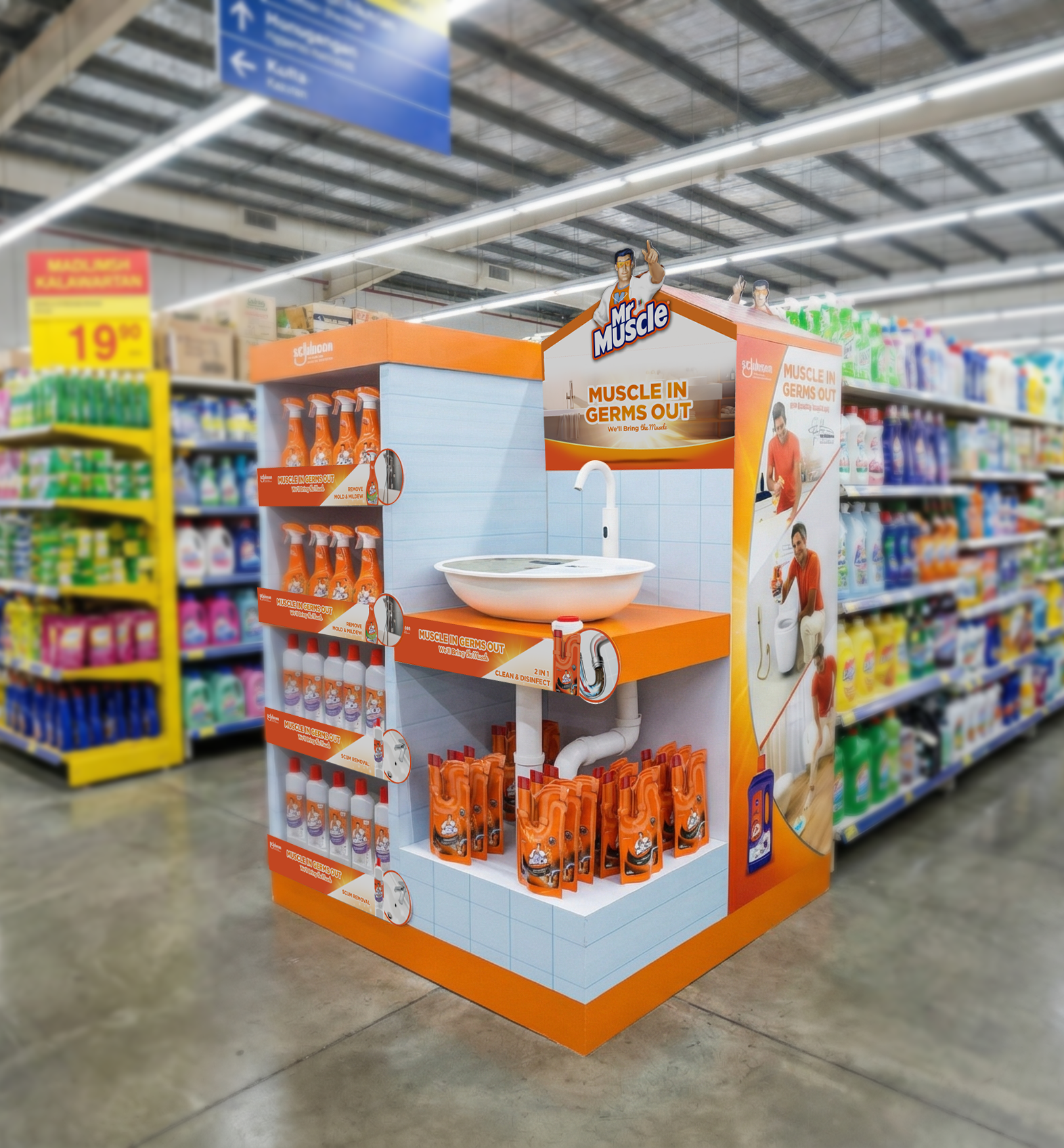 The Mr Muscle sink/drain block display in retail — a 1:1 scale-model bathroom sink with chrome faucet, and beneath the counter, the exposed U-bend pipework merchandising drain-cleaner pouches inside the trap itself.