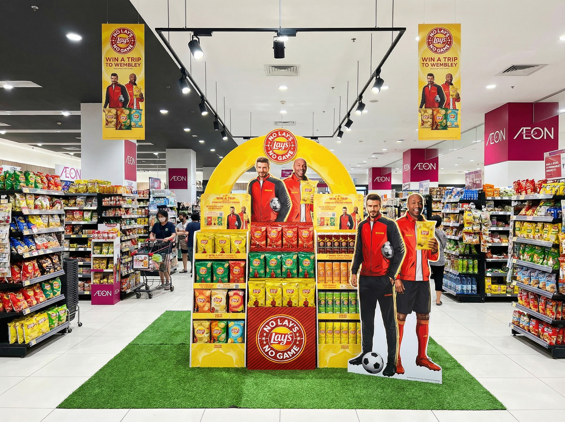 Lay's UCL 2024 Win A Trip to Wembley activation at AEON Malaysia with overhead mall signage and Beckham Henry standees — sports sponsorship POSM by creative agency Kuala Lumpur